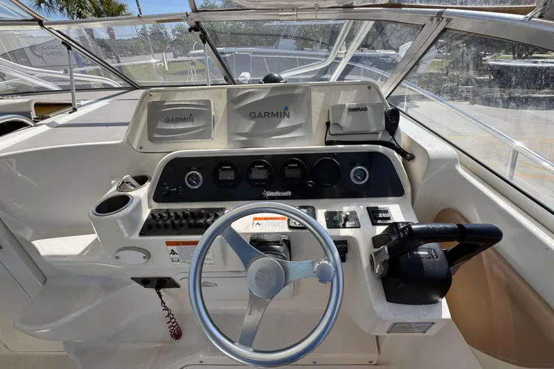 Slide: The Image of 2004 Wellcraft 290 Coastal boat helm with Garmin navigation and steering wheel. - 22