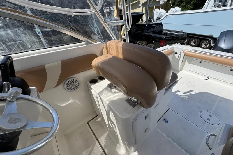 Slide: The Image of 2004 Wellcraft 290 Coastal boat interior with tan seating and steering wheel. - 23