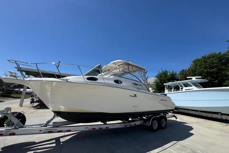 Slide: The Image of 2004 Wellcraft 290 Coastal boat on trailer under clear blue sky. - 3