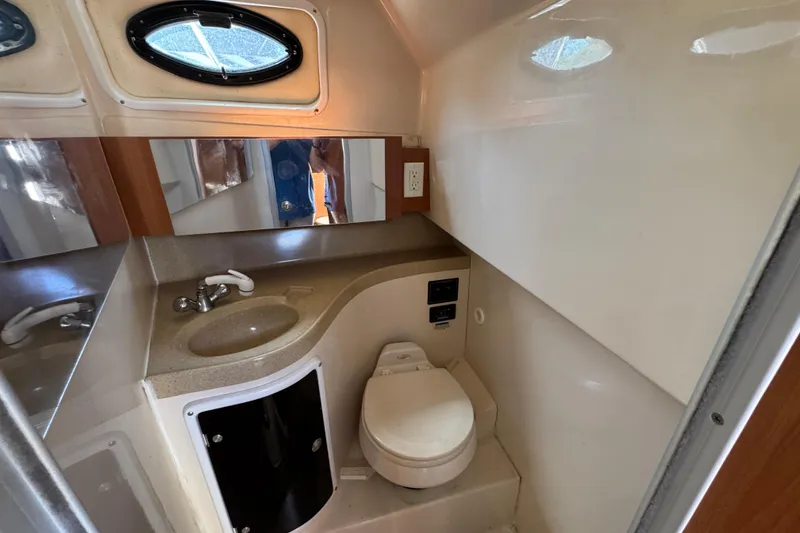 Slide: The Image of 2004 Wellcraft 290 Coastal boat bathroom with sink, toilet, and mirror. - 30