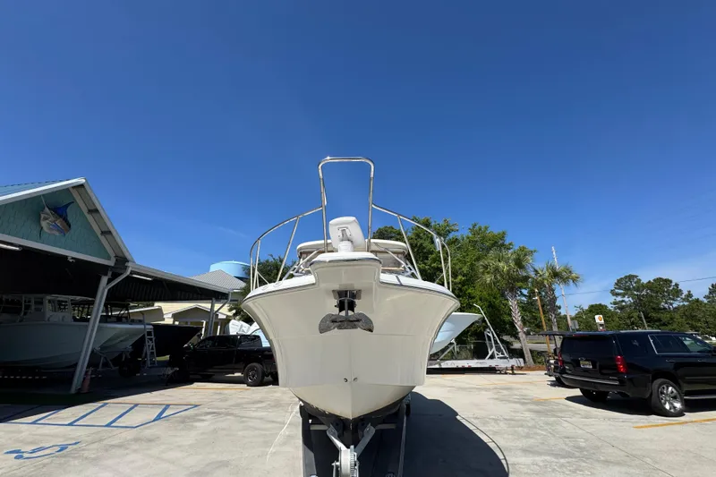 Slide: The Image of 2004 Wellcraft 290 Coastal boat on trailer under clear blue sky. - 6