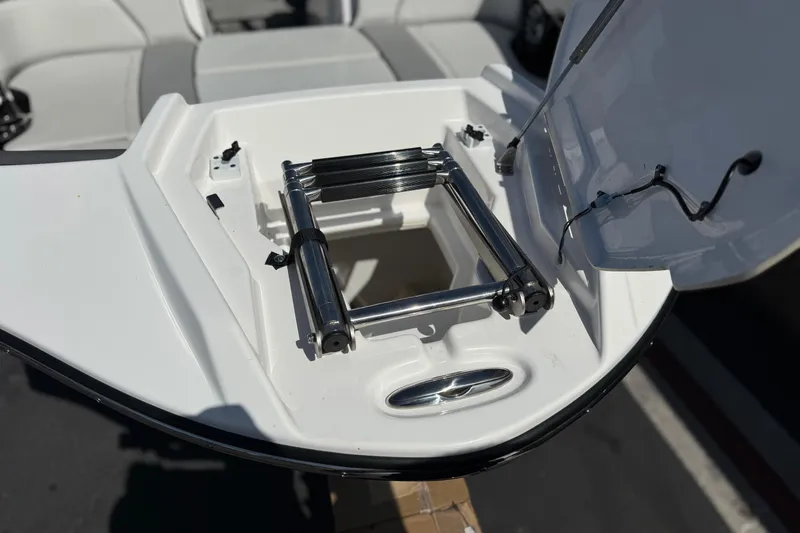 Slide: The Image of 2024 Yamaha Boats 252XE swim platform with retractable ladder and storage compartment. - 13