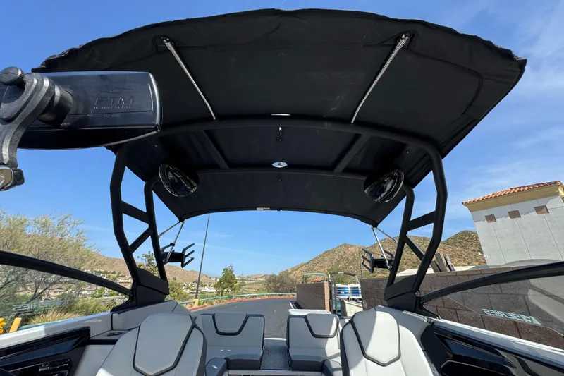 Slide: The Image of 2024 Yamaha Boats 252XE interior with sleek seating and canopy, showcasing modern design. - 18