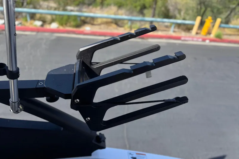 Slide: The Image of Wakeboard rack on 2024 Yamaha Boats 252XE, black metal design, outdoor setting. - 19