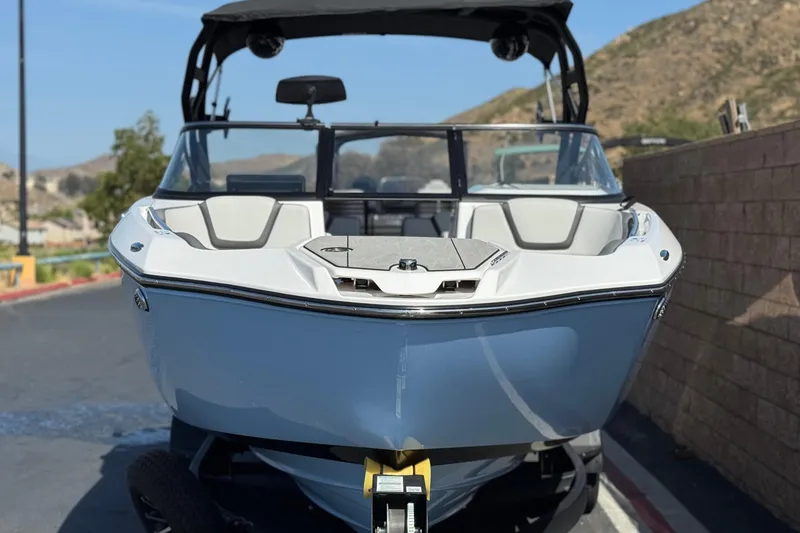 Slide: The Image of 2024 Yamaha Boats 252XE, sleek design, parked outdoors, front view. - 2