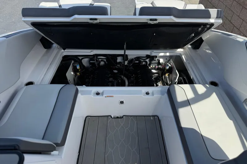 Slide: The Image of Open engine compartment of 2024 Yamaha Boats 252XE, showcasing dual engines and seating area. - 23