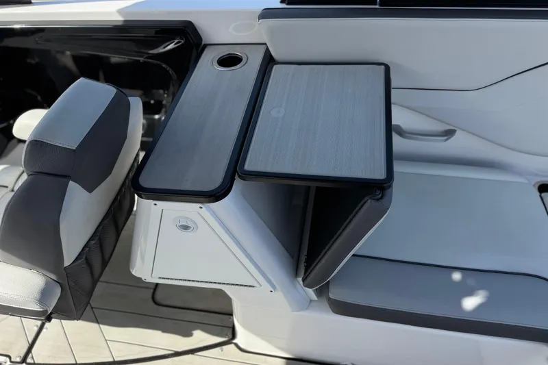 Slide: The Image of 2024 Yamaha Boats 252XE interior with sleek seating and foldable table design. - 26