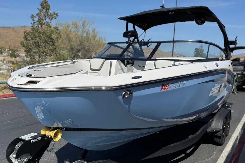 Slide: The Image of 2024 Yamaha Boats 252XE in blue, parked on a trailer, showcasing sleek design and modern features. - 3