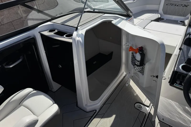 Slide: The Image of 2024 Yamaha Boats 252XE interior with open storage compartment and seating area. - 31