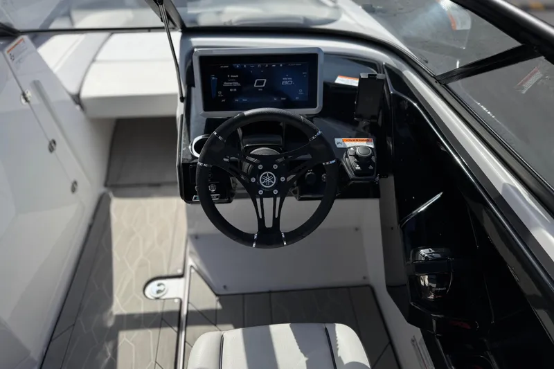 Slide: The Image of 2024 Yamaha Boats 252XE cockpit with modern steering wheel and digital display. - 35