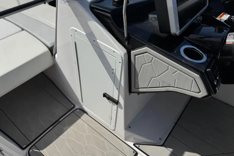 Slide: The Image of 2024 Yamaha Boats 252XE interior detail with modern console and seating area. - 42