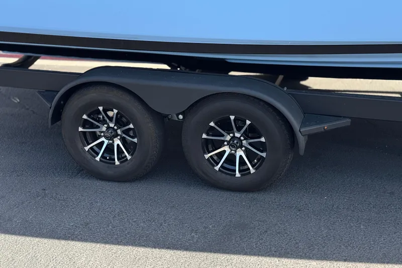 Slide: The Image of Trailer wheels of a 2024 Yamaha Boats 252XE on pavement. - 44