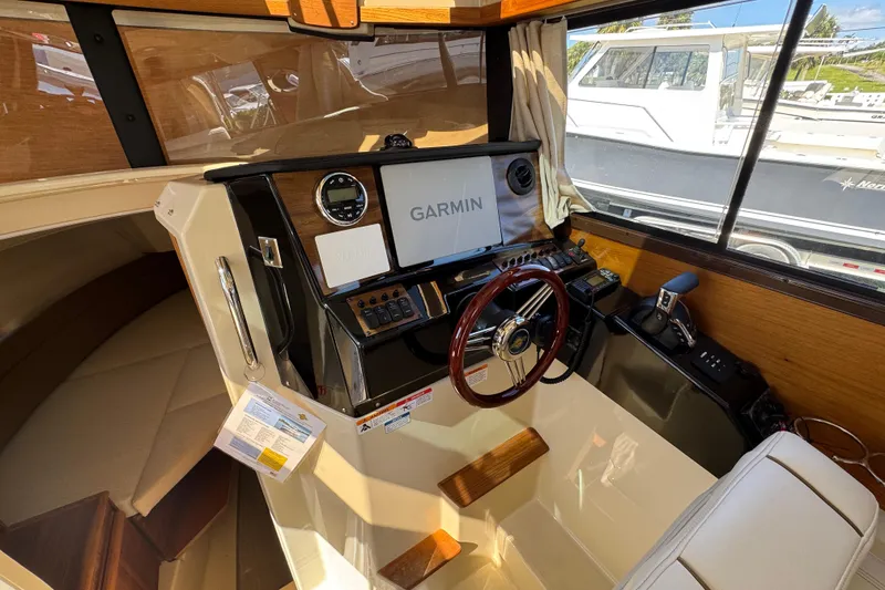 Slide: The Image of Interior cockpit of 2026 Ranger Tugs R-25 with Garmin navigation system. - 7