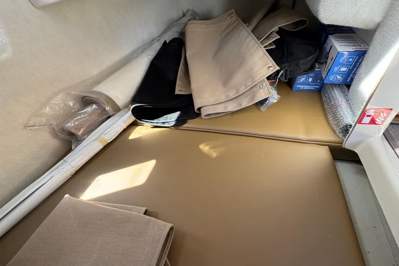 Slide: The Image of Interior storage area of 2026 Ranger Tugs R-25 with cushions and accessories. - 8