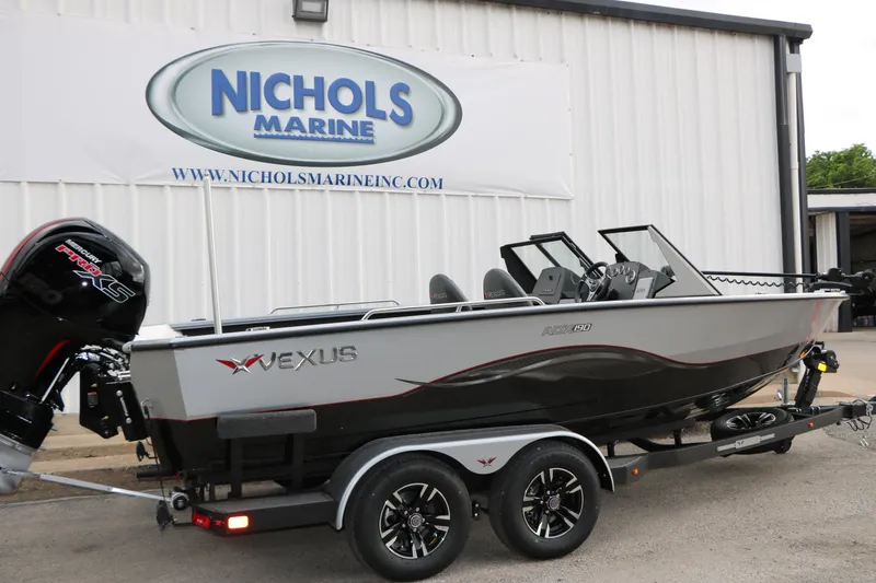 Slide: The Image of 2026 Vexus ADX 190 boat at Nichols Marine dealership, featuring sleek design and powerful engine. - 11