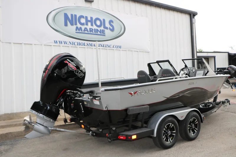 Slide: The Image of 2026 Vexus ADX 190 boat at Nichols Marine, featuring powerful outboard motor. - 12