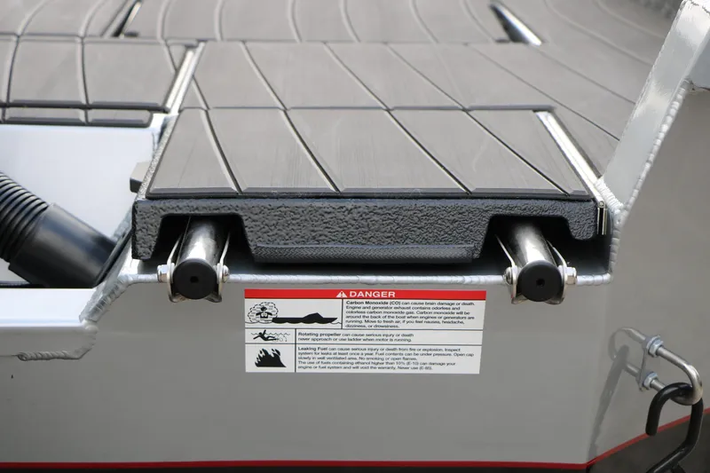 Slide: The Image of 2026 Vexus ADX 190 boat deck with safety warning label and metal fittings. - 16