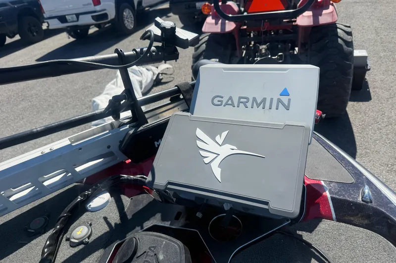 Slide: The Image of Garmin device on 2020 Skeeter FXR20 Limited boat, parked near a red vehicle. - 5