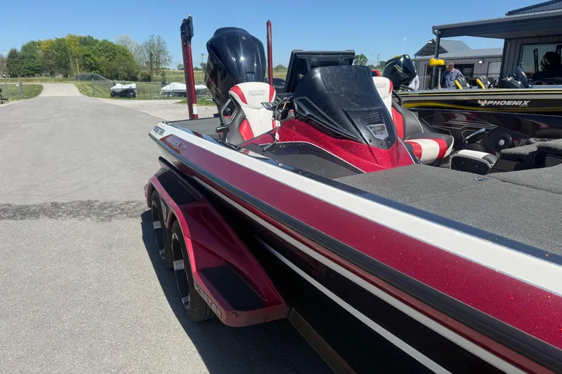 Slide: The Image of 2020 Skeeter FXR20 Limited boat with red and white detailing parked outdoors. - 7