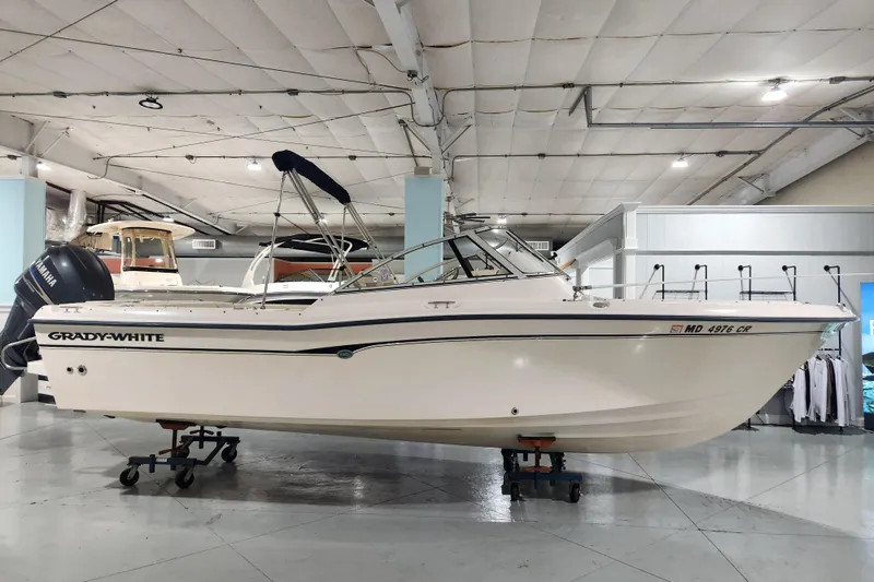 The Image of 2007 Grady-White Tournament 225 boat displayed indoors with Yamaha engine. - 0