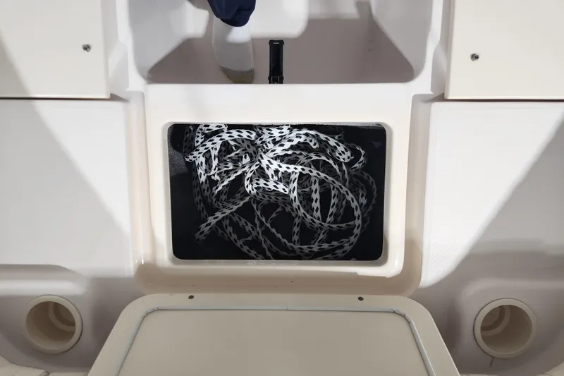 Slide: The Image of 2007 Grady-White Tournament 225 boat bow storage compartment, open and empty. - 10