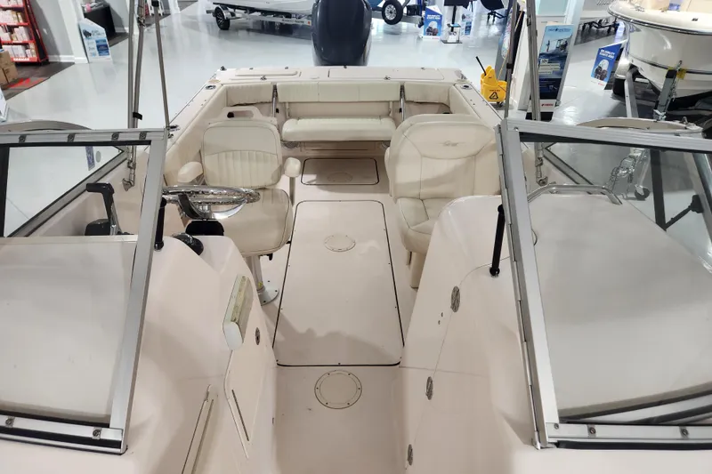 Slide: The Image of 2007 Grady-White Tournament 225 boat interior with white captain's chair and steering wheel. - 14