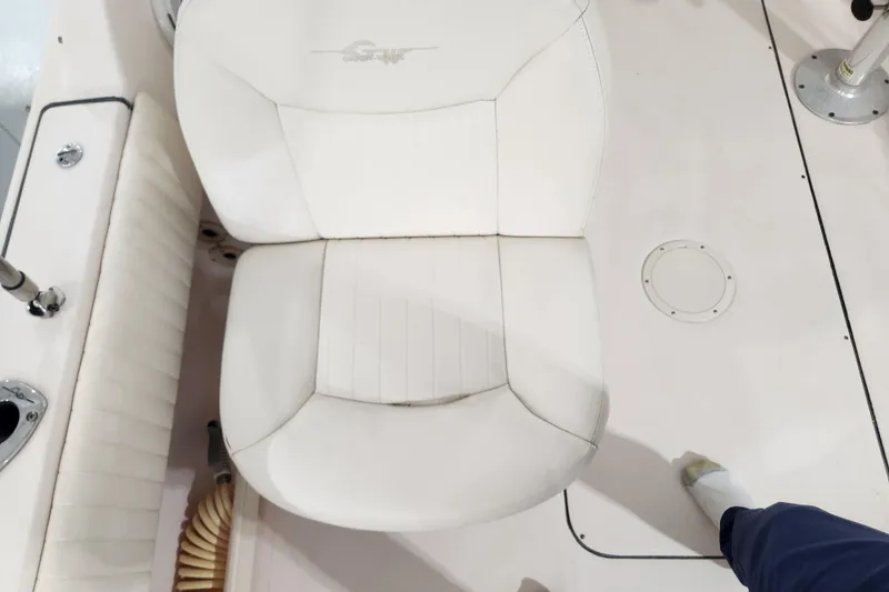 Slide: The Image of 2007 Grady-White Tournament 225 boat interior with white seating and steering wheel. - 15