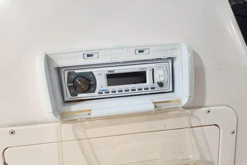 Slide: The Image of 2007 Grady-White Tournament 225 boat interior with cushioned seating and storage compartments. - 18