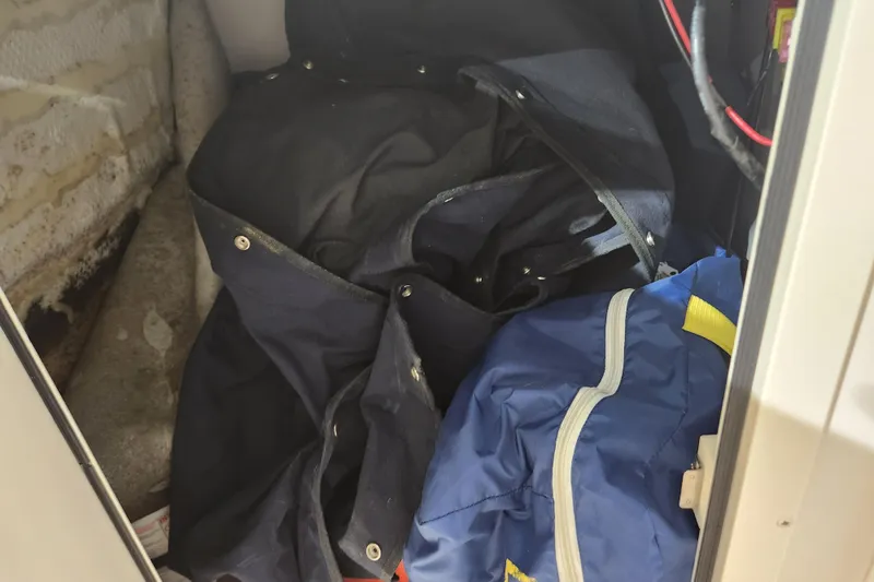 Slide: The Image of Interior view of a 2007 Grady-White Tournament 225 boat with white seating and storage compartment. - 21