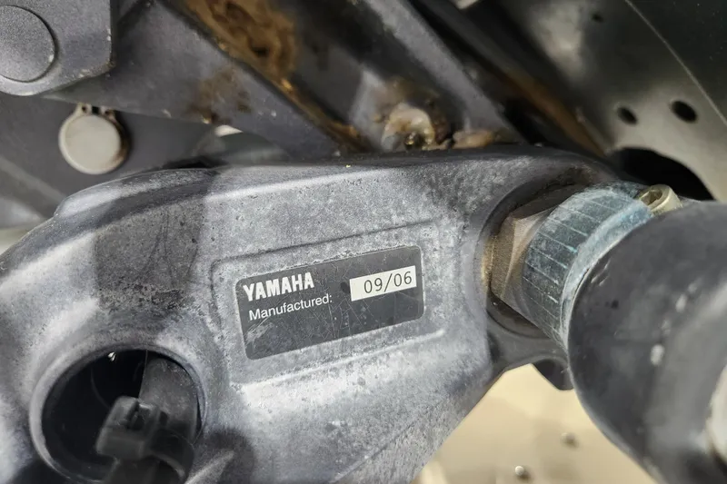 Slide: The Image of Interior of 2007 Grady-White Tournament 225 boat with white seating and coiled hose. - 27