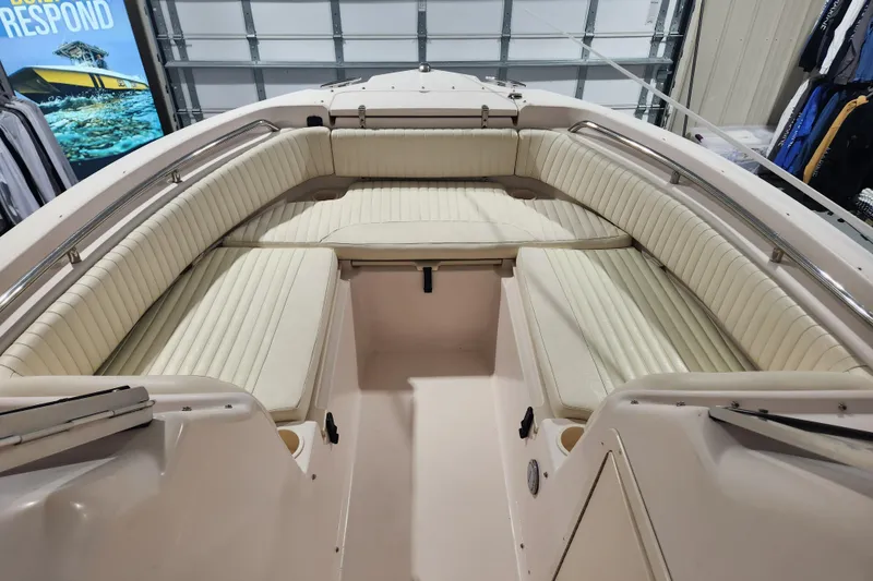 Slide: The Image of 2007 Grady-White Tournament 225 boat interior with cushioned seating in a showroom. - 7