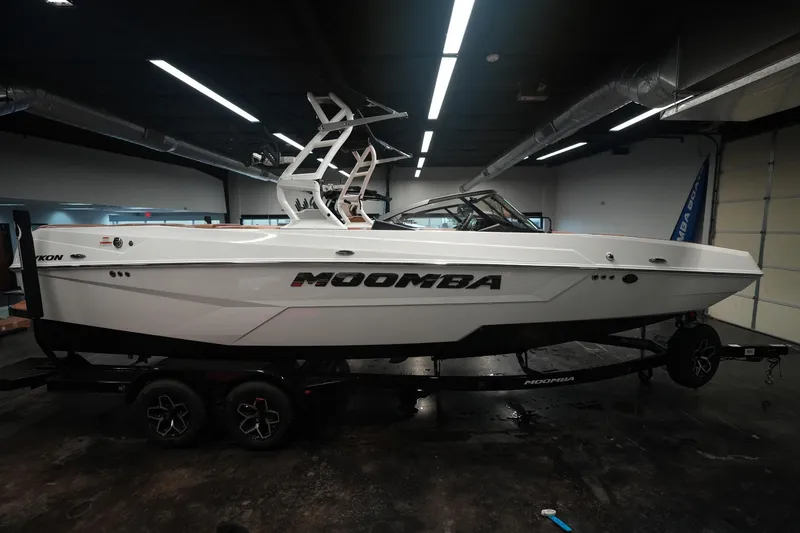 Slide: The Image of 2026 Moomba Tykon boat in a garage on a trailer. - 12