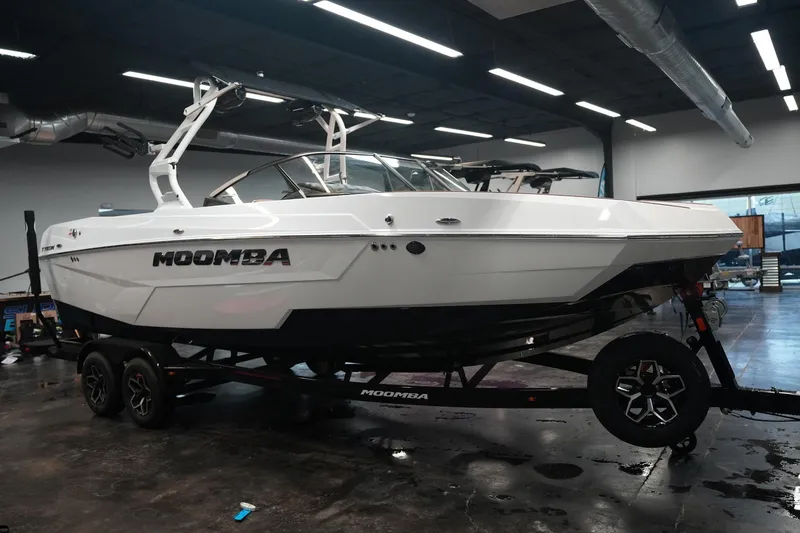 Slide: The Image of 2026 Moomba Tykon boat displayed in a showroom. - 6