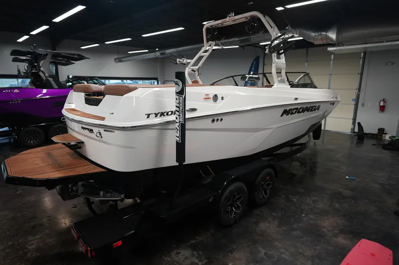 Slide: The Image of 2026 Moomba Tykon boat in a showroom. - 7