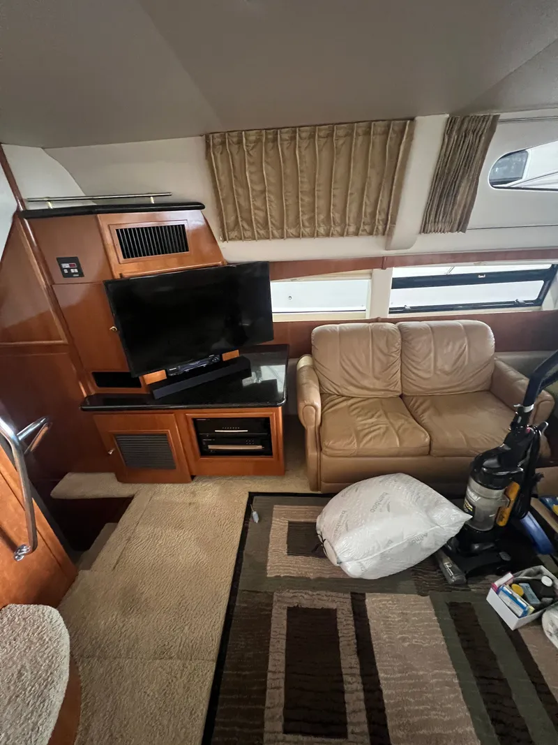 Slide: The Image of Interior of a 2002 Carver 466 Motor Yacht with sofa and TV. - 16
