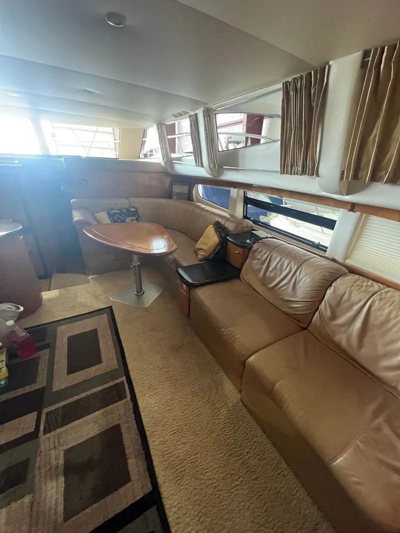 Slide: The Image of Interior of 2002 Carver 466 Motor Yacht with leather sofa and dining table. - 23