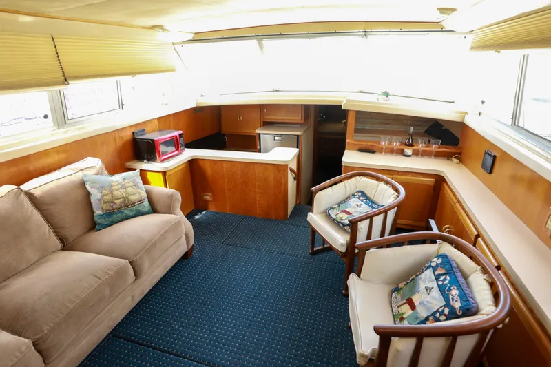 Slide: The Image of Interior of a 1991 Silverton 41 Aft Cabin yacht with cozy seating and kitchenette. - 10