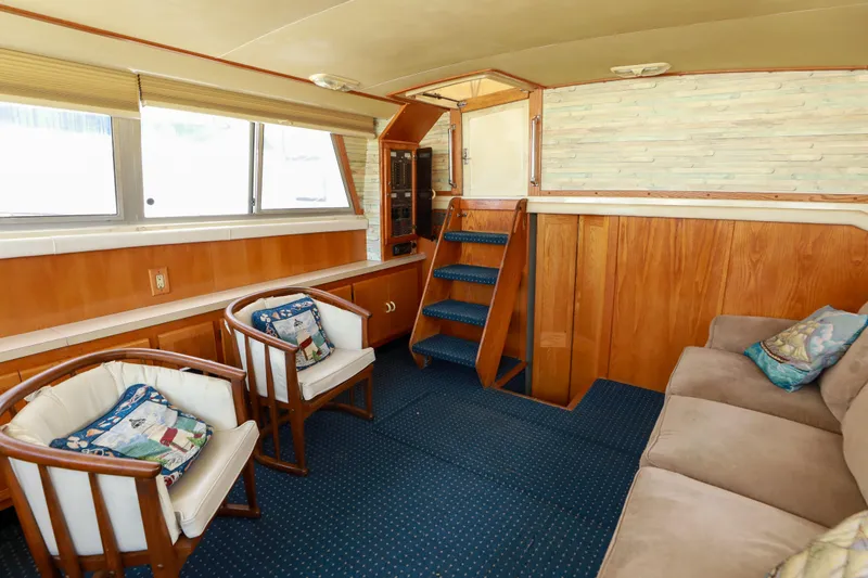 Slide: The Image of Interior of 1991 Silverton 41 Aft Cabin yacht with cozy seating and nautical decor. - 12