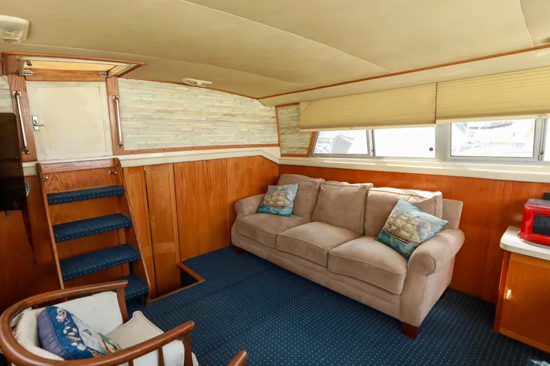 Slide: The Image of Interior of 1991 Silverton 41 Aft Cabin yacht with cozy seating and wooden accents. - 13