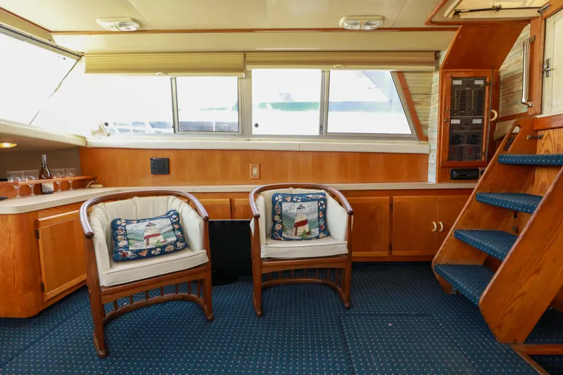 Slide: The Image of Interior of 1991 Silverton 41 Aft Cabin with sofa, stairs, and windows. - 14