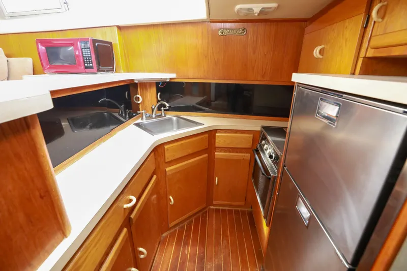 Slide: The Image of Interior of 1991 Silverton 41 Aft Cabin with chairs, nautical decor, and wooden cabinetry. - 15