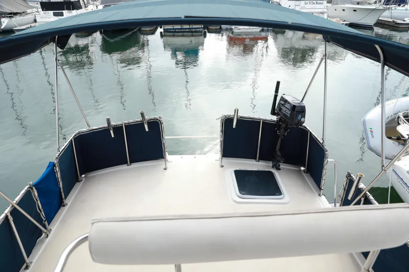 Slide: The Image of 1991 Silverton 41 Aft Cabin boat deck with canopy, docked in marina. - 2