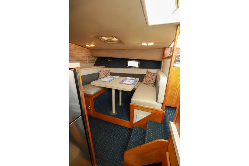 Slide: The Image of 1991 Silverton 41 Aft Cabin kitchen with stainless steel stove and wooden cabinetry. - 21