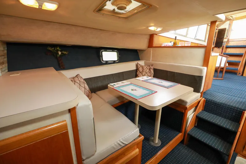 Slide: The Image of Interior of 1991 Silverton 41 Aft Cabin with dining area and seating. - 22