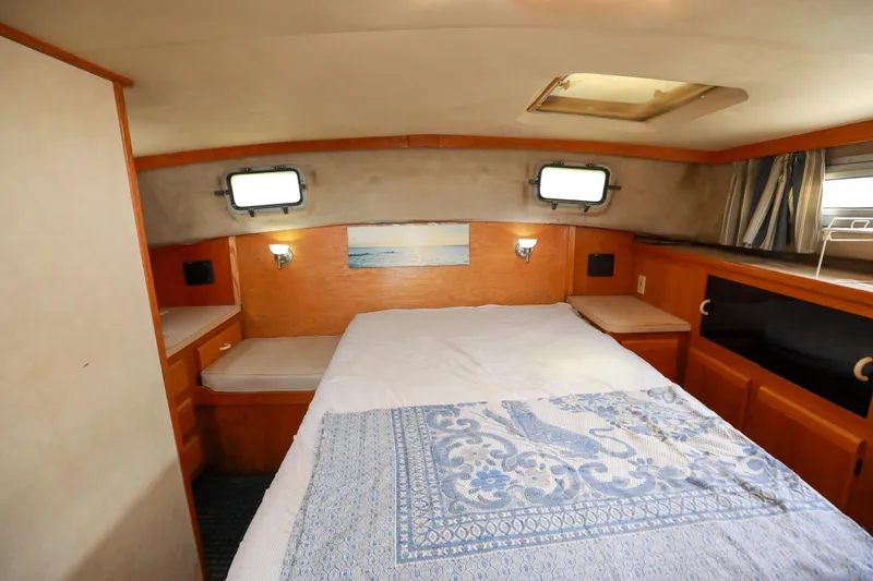 Slide: The Image of 1991 Silverton 41 Aft Cabin interior with dining area and stairs. - 23