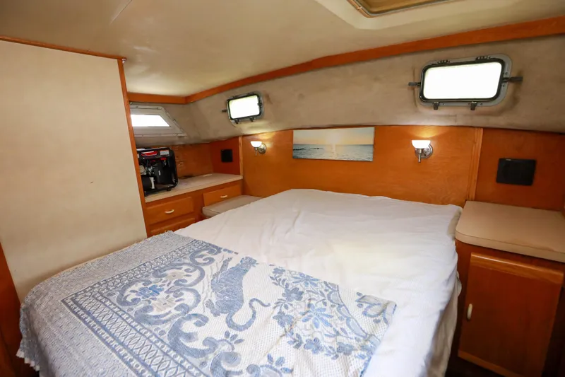 Slide: The Image of Cozy cabin interior of 1991 Silverton 41 Aft Cabin with bed and portholes. - 24