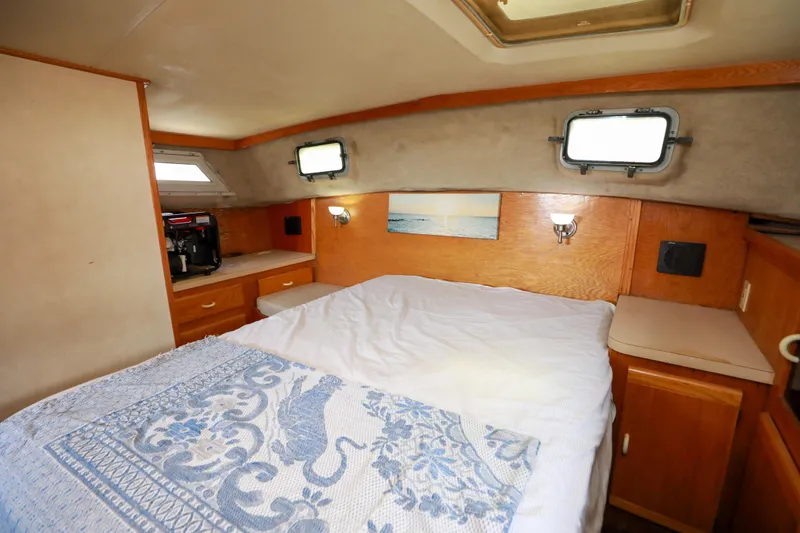 Slide: The Image of Cozy cabin interior of 1991 Silverton 41 Aft Cabin with bed and wooden storage. - 29