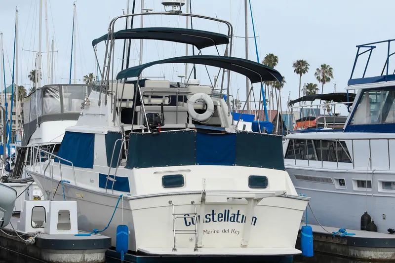 Slide: The Image of 1991 Silverton 41 Aft Cabin yacht docked at Marina del Rey, surrounded by other boats. - 3