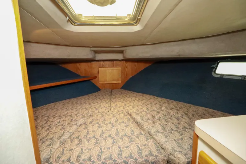 Slide: The Image of 1991 Silverton 41 Aft Cabin bathroom with wooden cabinetry, mirror, and sink. - 33