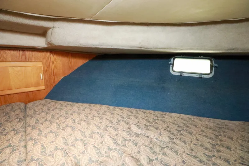 Slide: The Image of 1991 Silverton 41 Aft Cabin interior with cozy bed and wooden accents. - 35
